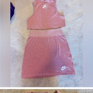 Women’s two piece Nike athletic wear skirt with crop top. Size medium